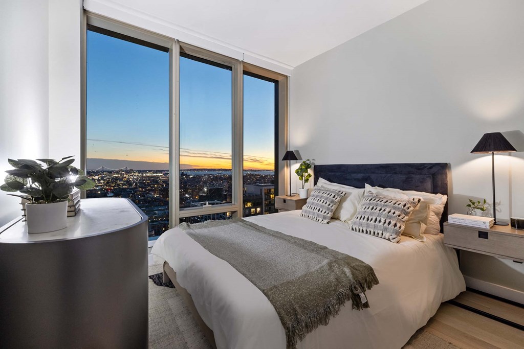 a bedroom with a bed and a view of the city at The Paxton, Brooklyn